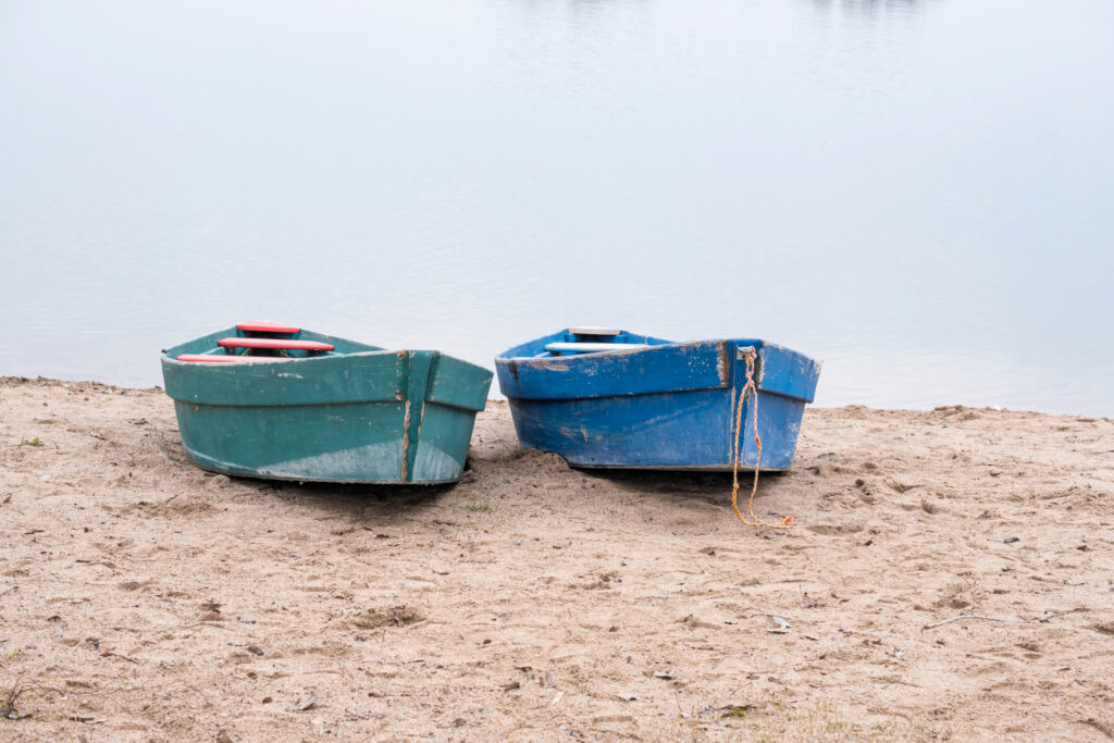 Two,Old,Boats,On,The,Sandy,Shore.,Two,Small,Wooden
